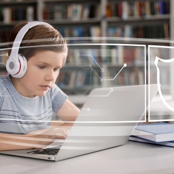 Child with headphones on safe computer with lock icon 